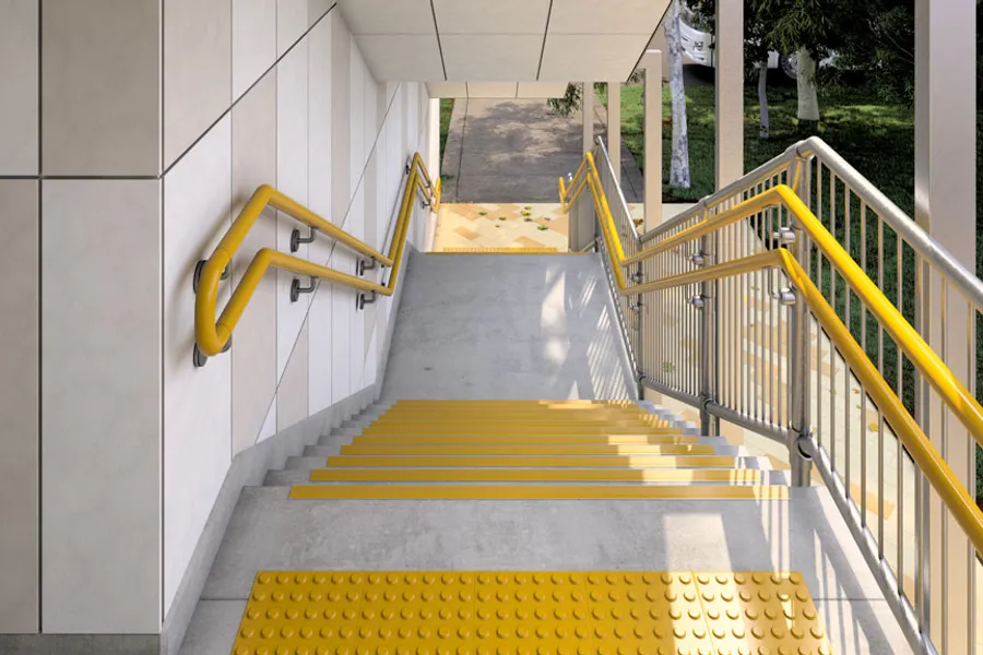 Stairway with yellow treads and double handrails for safety.