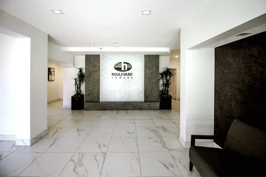 Image of the redesigned lobby at Boulevard Towers, featuring marble flooring and a water feature