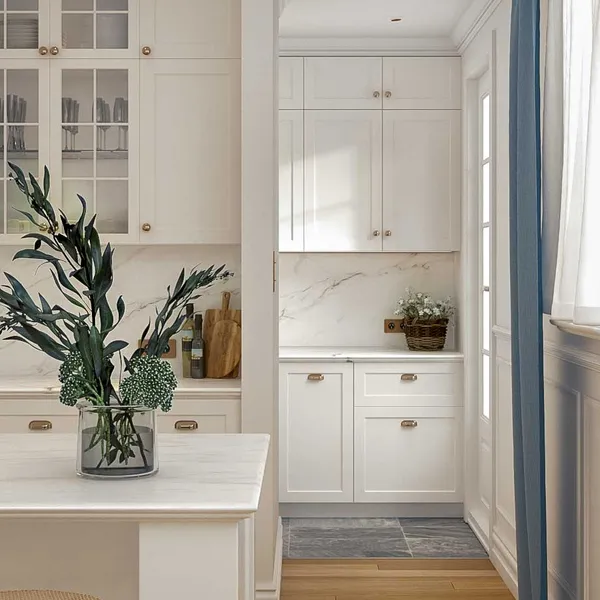 View into the kitchen's rear displaying Carrara marble benchtops and splashback, harmonizing with the white and blue color scheme and oak floors