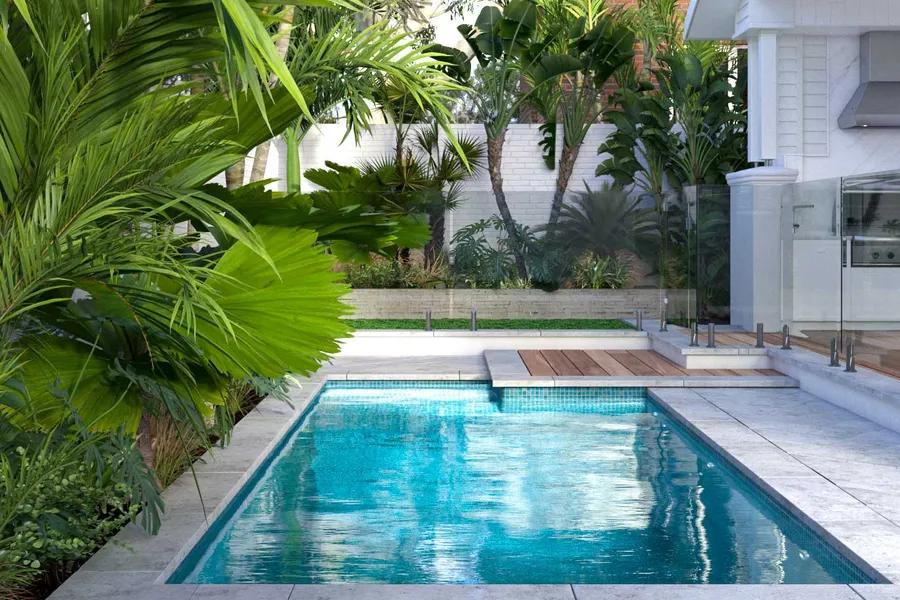 Glistening swimming pool surrounded by lush palm trees and tropical landscaping, echoing the coastal and contemporary design of the residence