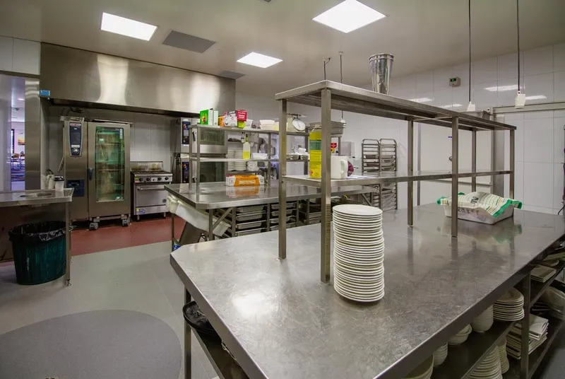Burleigh Leagues Kitchen - Main cooking line with commercial ovens, grills, and extraction hoods