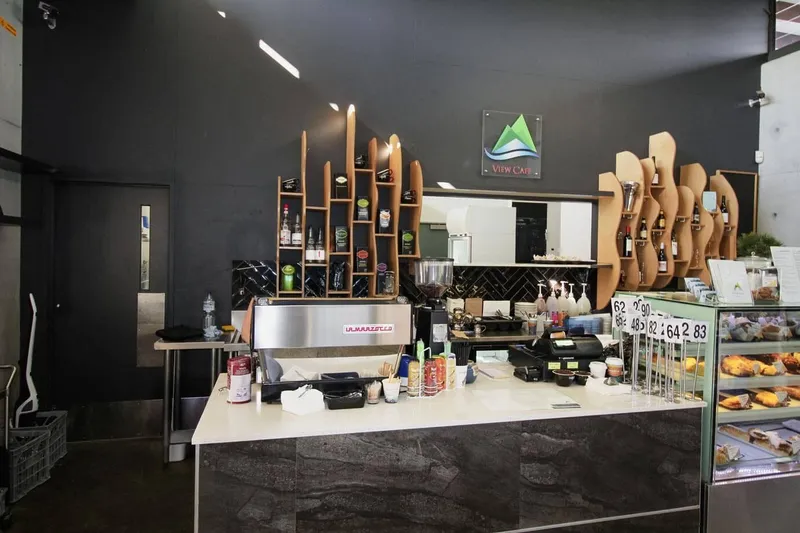 View Cafe custom timber shelving unit with sculpted wave forms