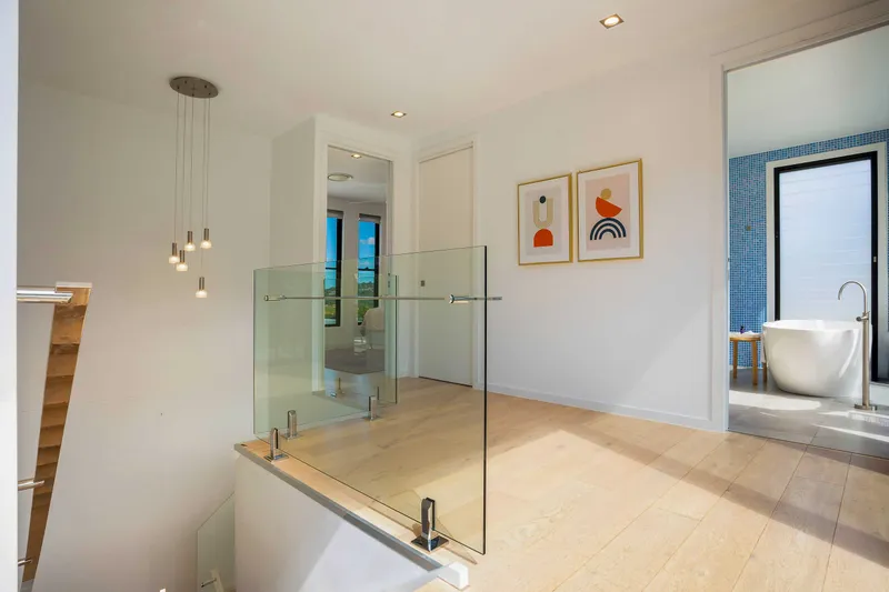 Master bedroom view capturing the coastal landscape through floor-to-ceiling glass