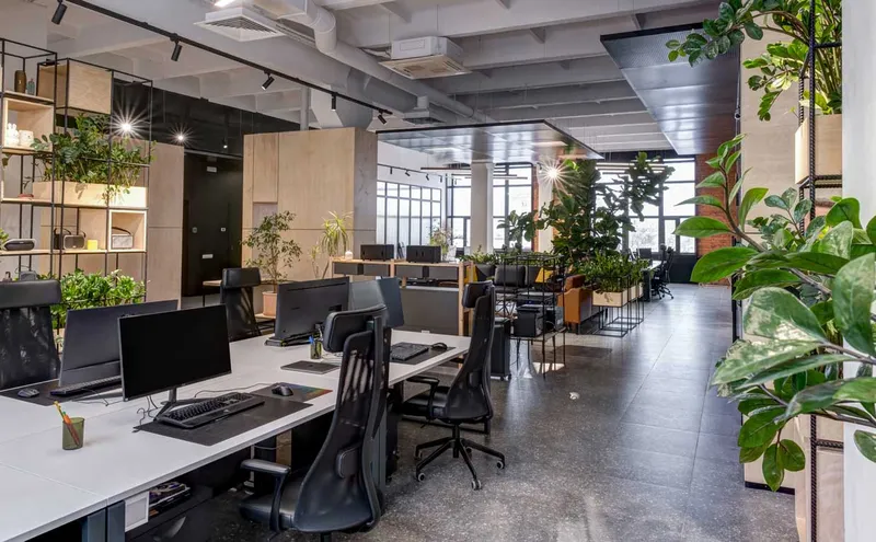 Modern office space with integrated planters around workstations.