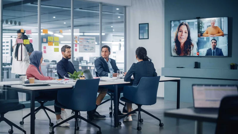 Meeting room equipped with video conferencing technology for hybrid collaboration.
