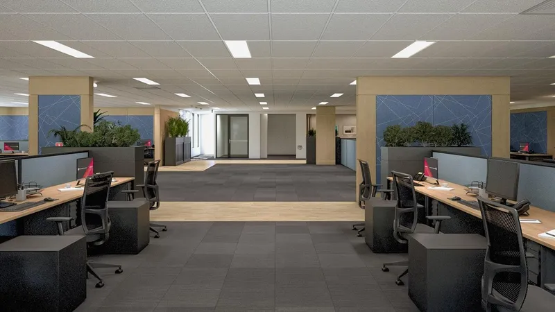 Wide view of open-plan office with linear workstations, acoustic panels, and planter dividers at QBuild's South Coast Offices
