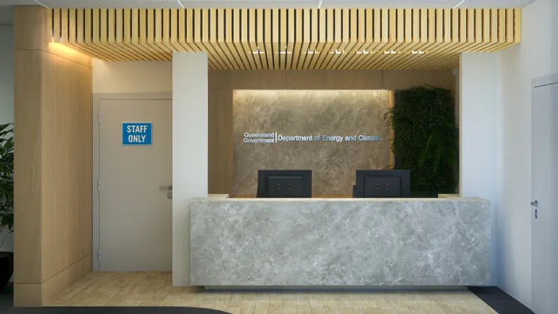 Reception area for QBuild's South Coast Offices with stone-look counter, timber slat ceiling, and greenery feature wall.