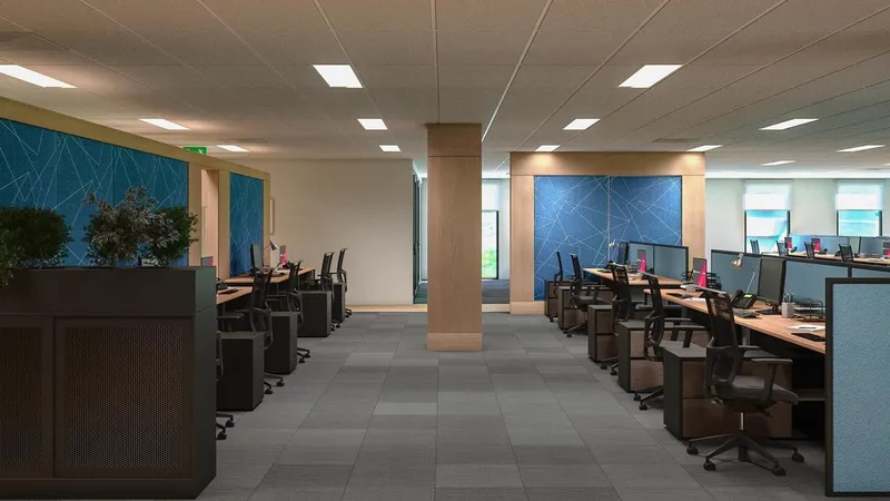 Central aisle view of open office with workstations, acoustic wall panels, and planter partitions at QBuild's South Coast Offices.