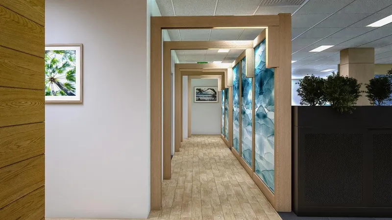 Timber-framed corridor with blue abstract feature wall and framed artwork at QBuild's South Coast Offices.