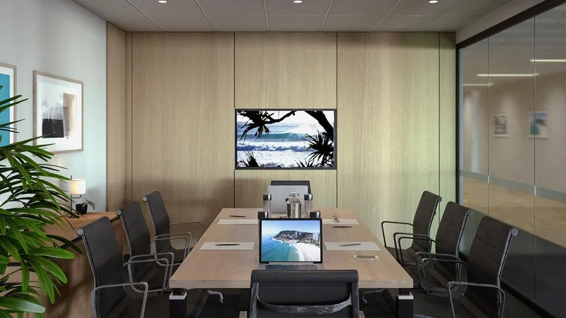 Boardroom at QBuild's South Coast Offices featuring timber finishes, leather chairs, built-in screen, and glass partition.